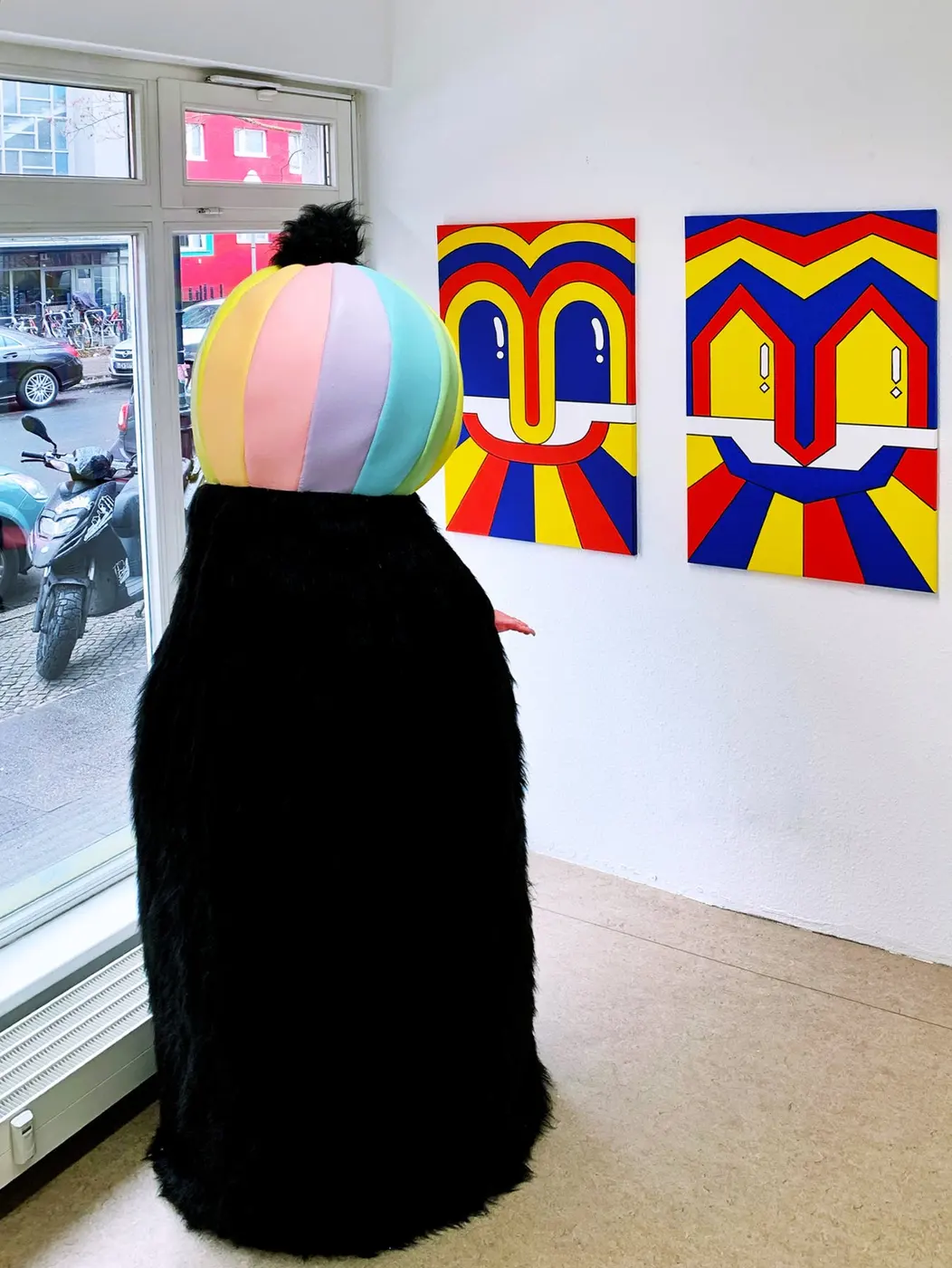 Visitor facing Julia Gaudard paintings in Milestone at Mauer Gallery